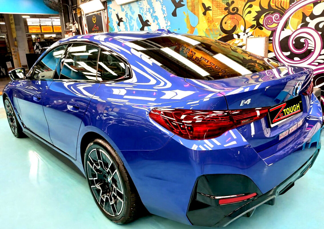 Rear quarter of the BMW i4, glossy and protected.