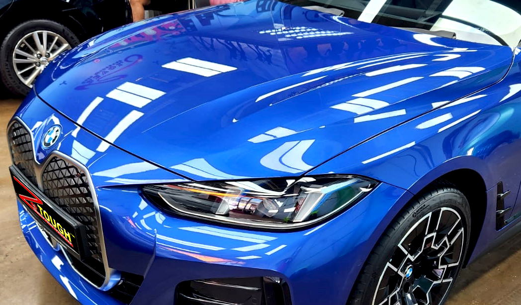 The BMW i4 from a side angle after the ceramic coating.