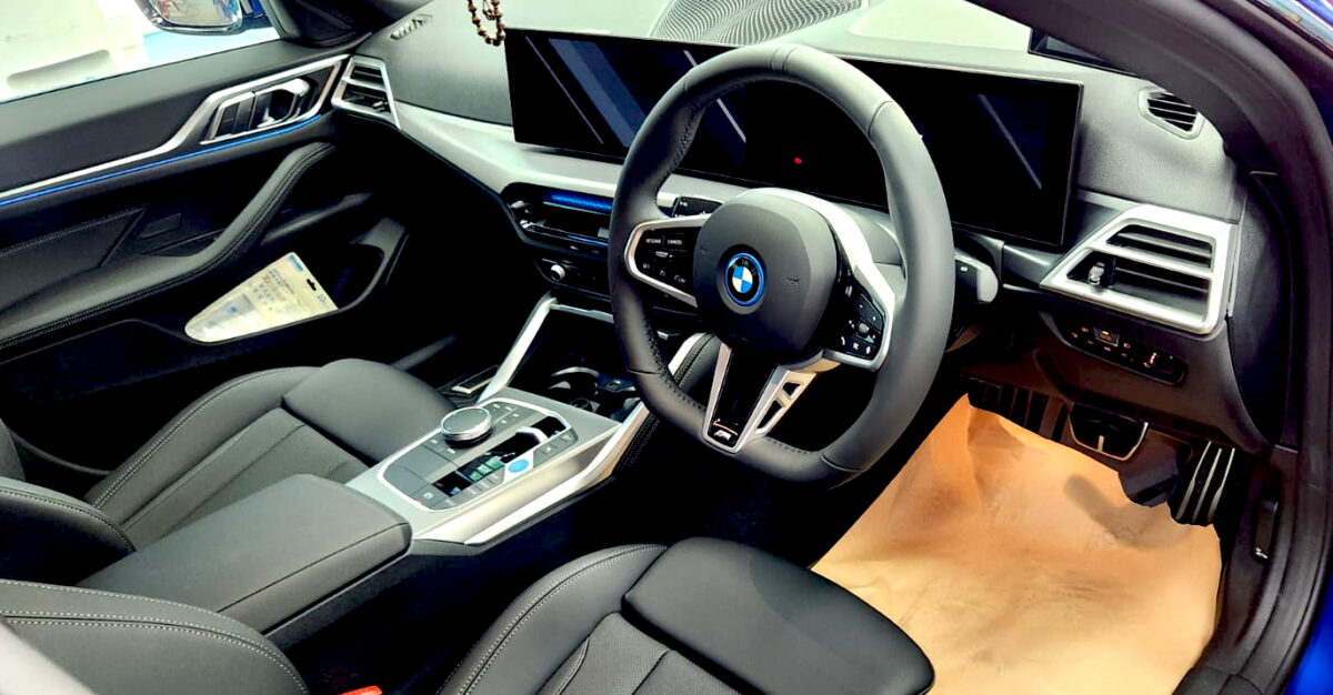 The BMW i4 parked in the workshop, freshly coated.