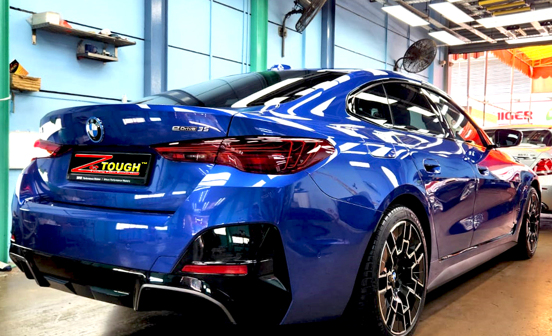 Rear quarter of the BMW i4, glossy and protected.