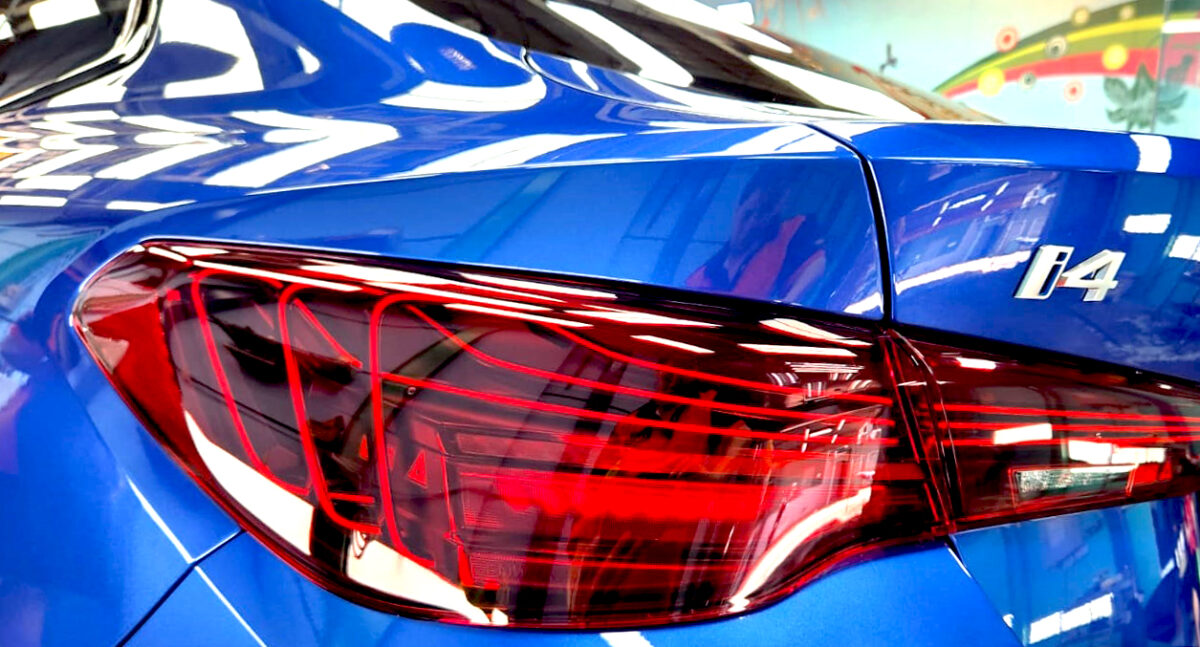The coated bonnet of the BMW i4 under workshop lighting.