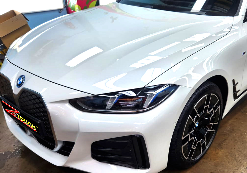 The BMW i4 from a side angle after the titanium coating.