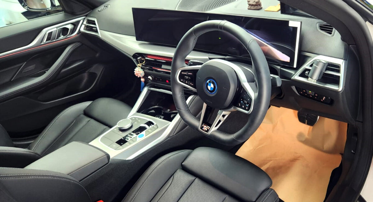 The BMW i4 parked in the workshop, freshly coated.