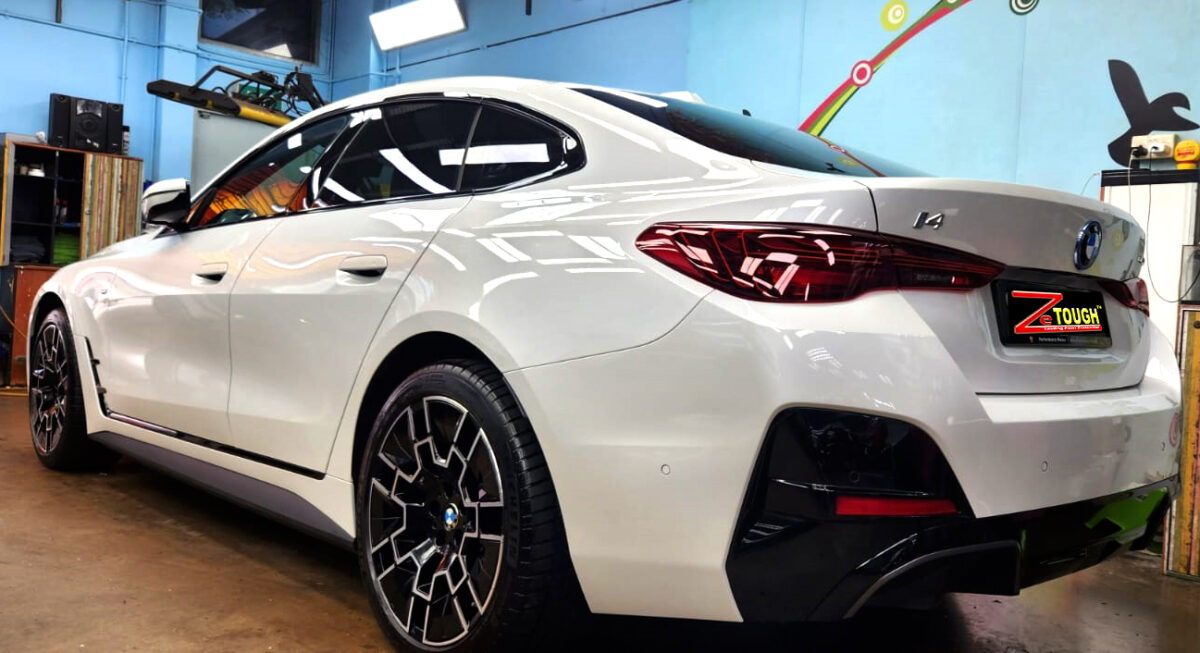 Rear quarter of the BMW i4, glossy and protected.