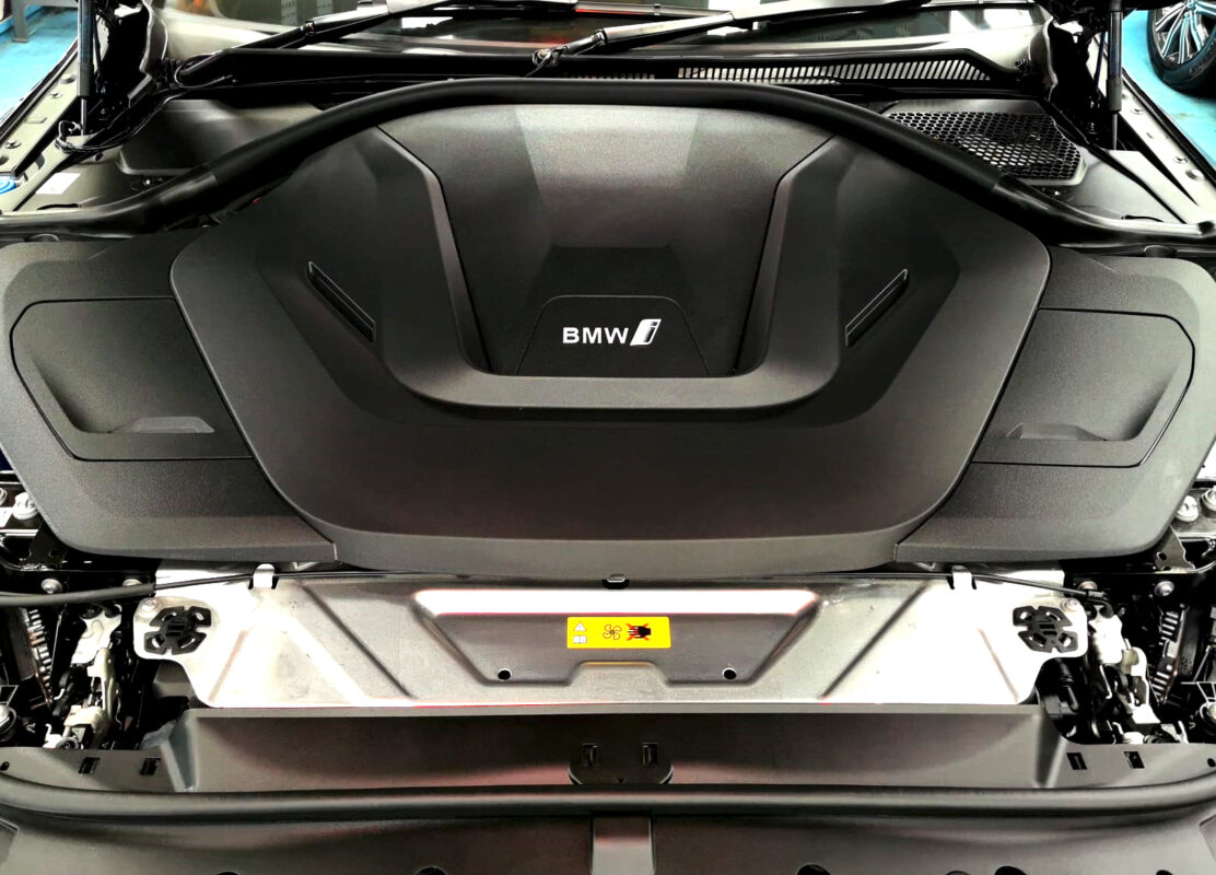 Reflections across the coated panels of the BMW i4.