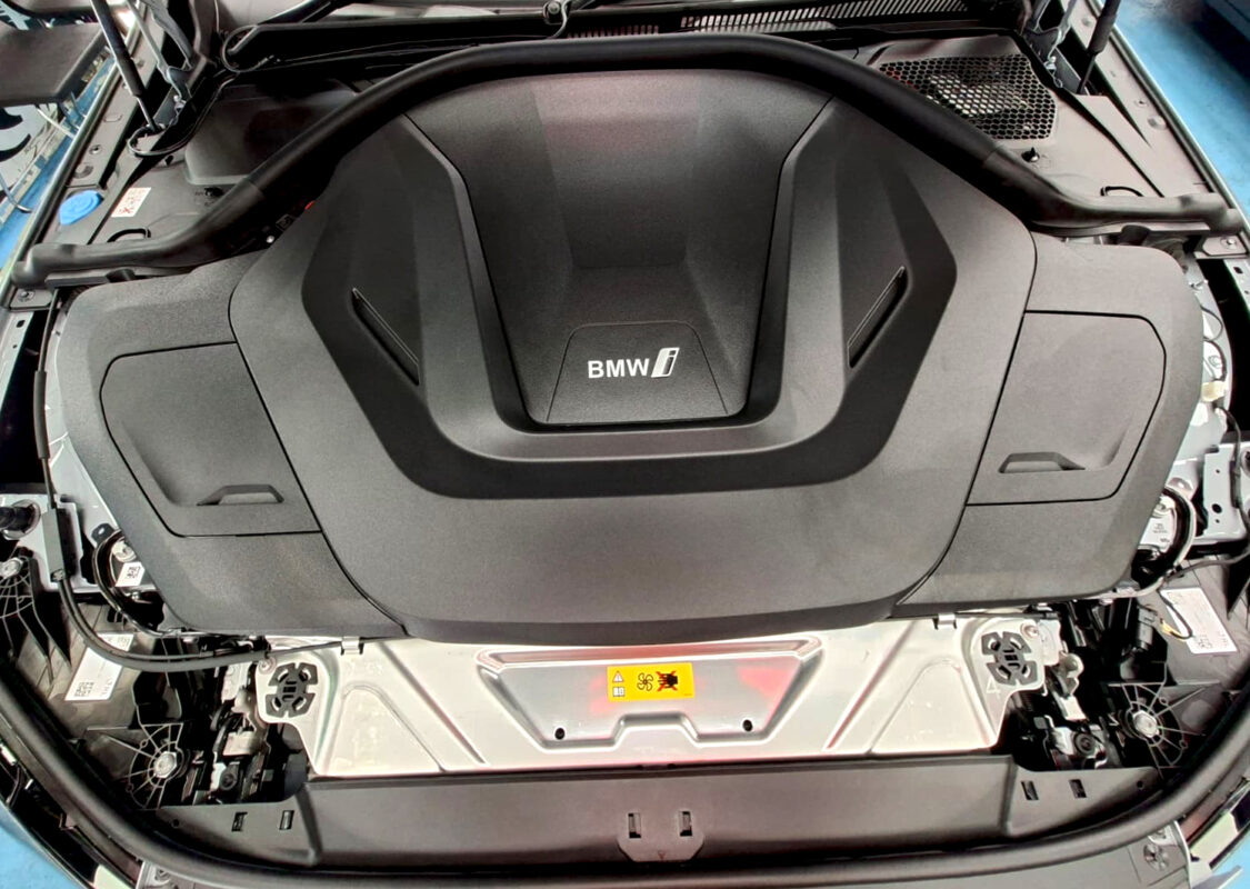 Reflections across the coated panels of the BMW i4.