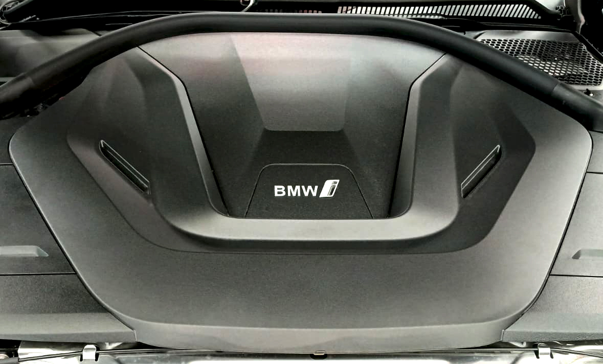 Reflections across the coated panels of the BMW i4.