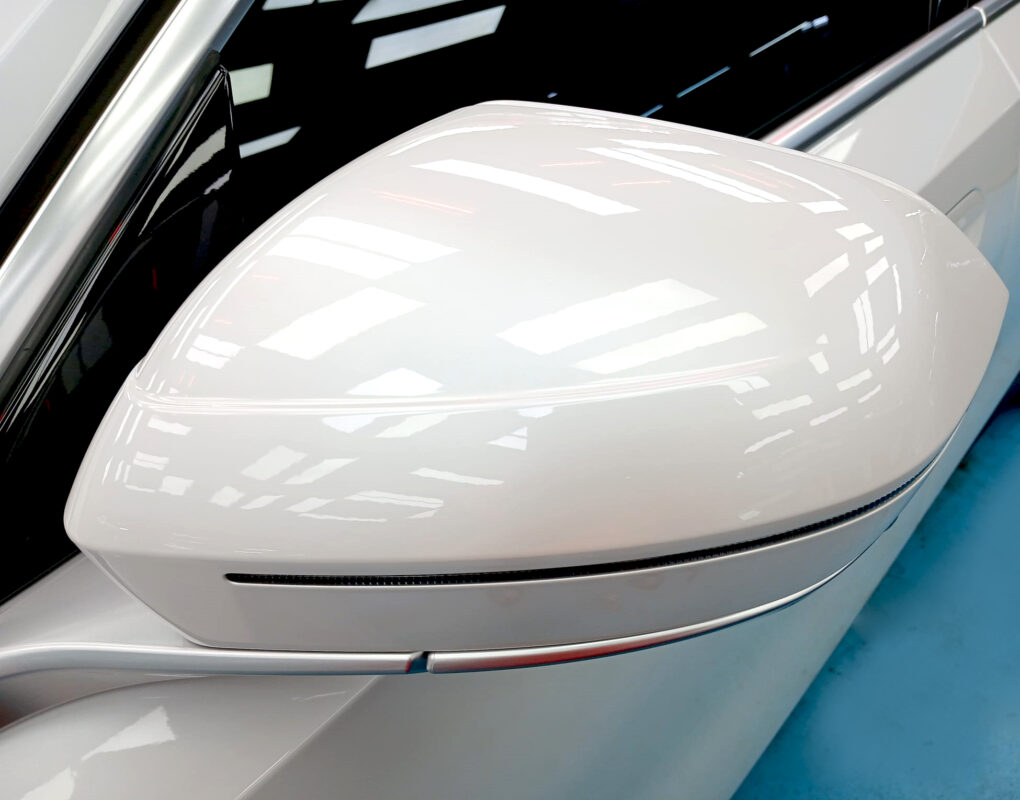 The BMW i5 parked in the workshop, freshly coated.
