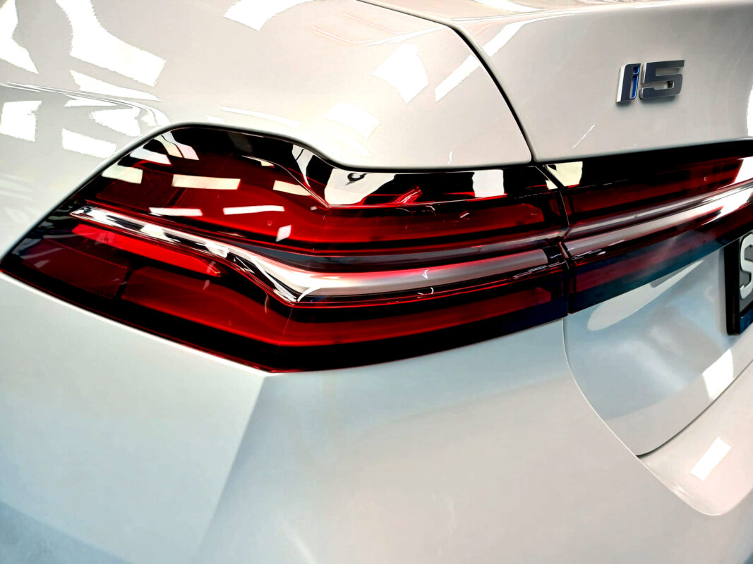 Rear quarter of the BMW i5, glossy and protected.