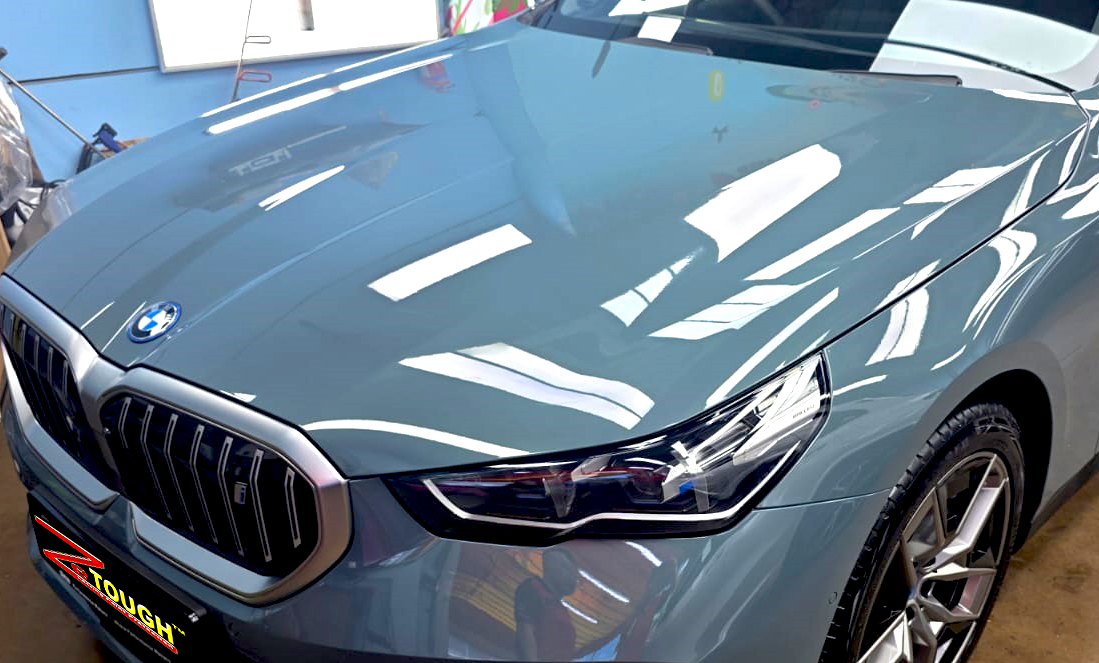 The BMW i5 from a side angle after the ceramic coating.