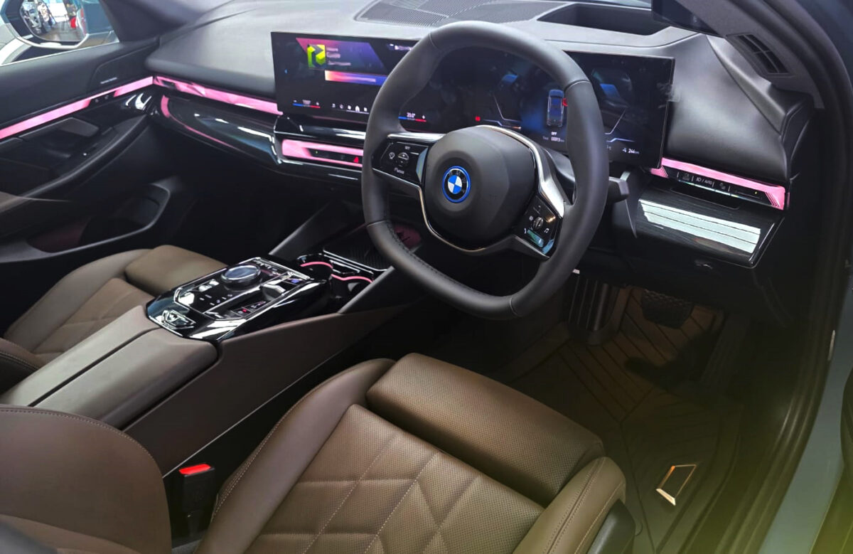 The BMW i5 parked in the workshop, freshly coated.