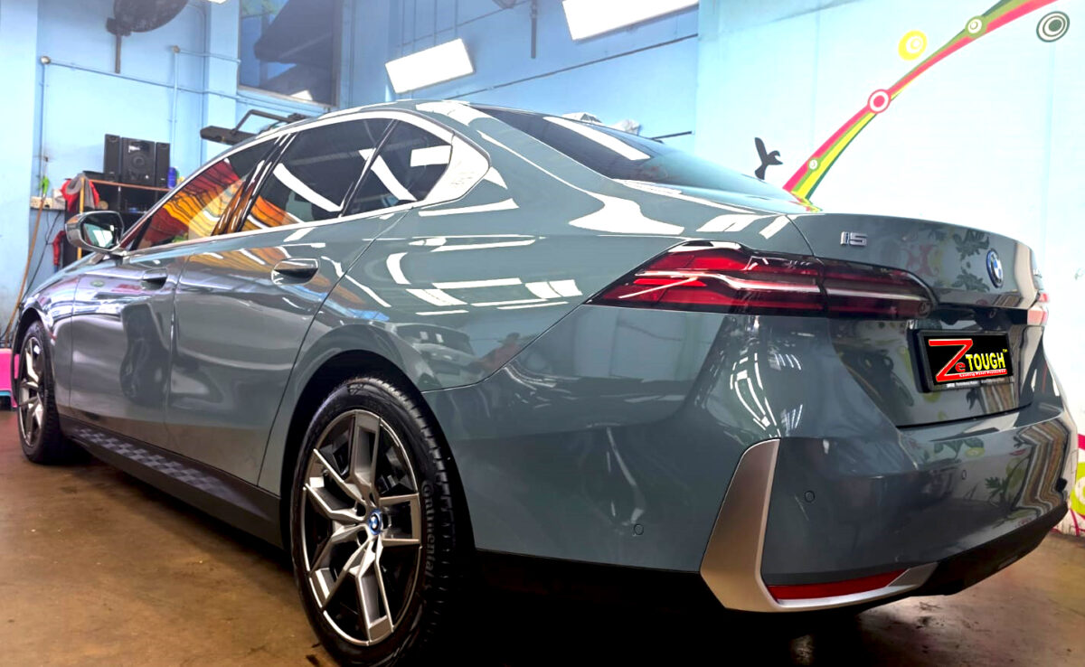 Rear quarter of the BMW i5, glossy and protected.