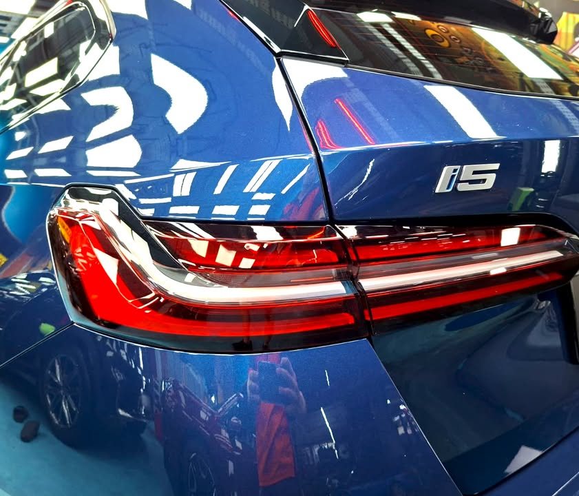 Close-up of the BMW i5 tail light and rear quarter with the i5 badge.