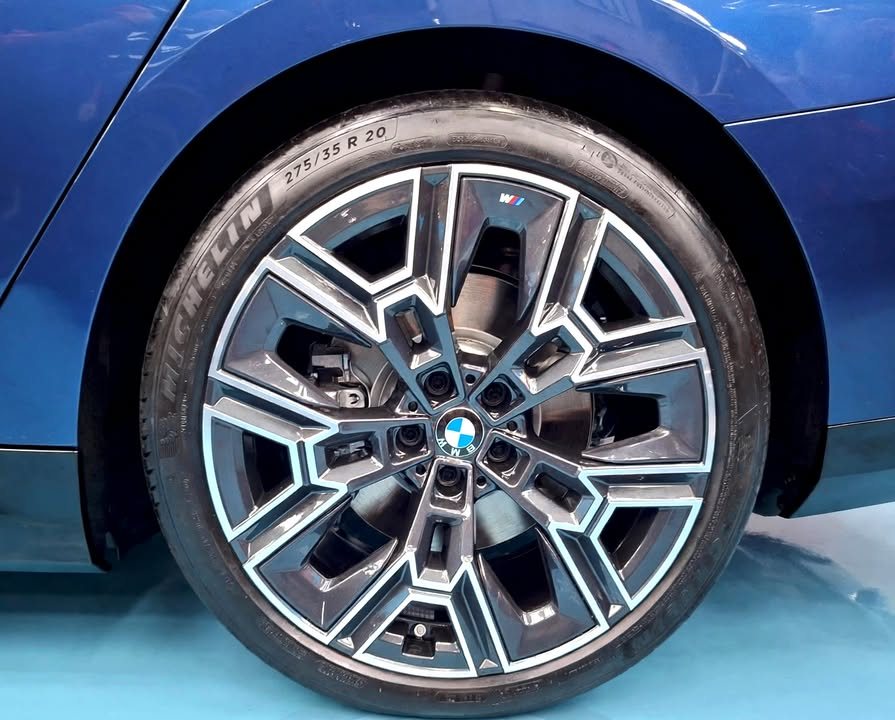 Close-up of the BMW i5 multi-spoke alloy wheel and tyre.