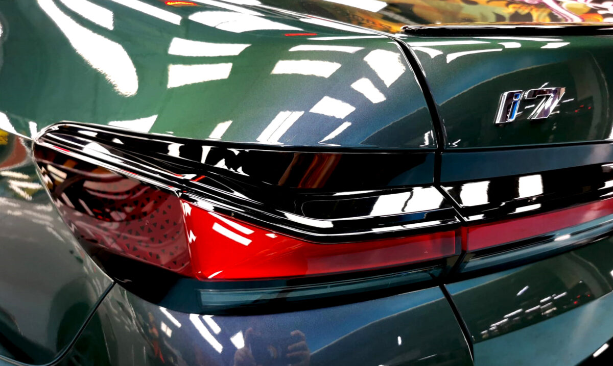 The coated bonnet of the BMW i7 under workshop lighting.