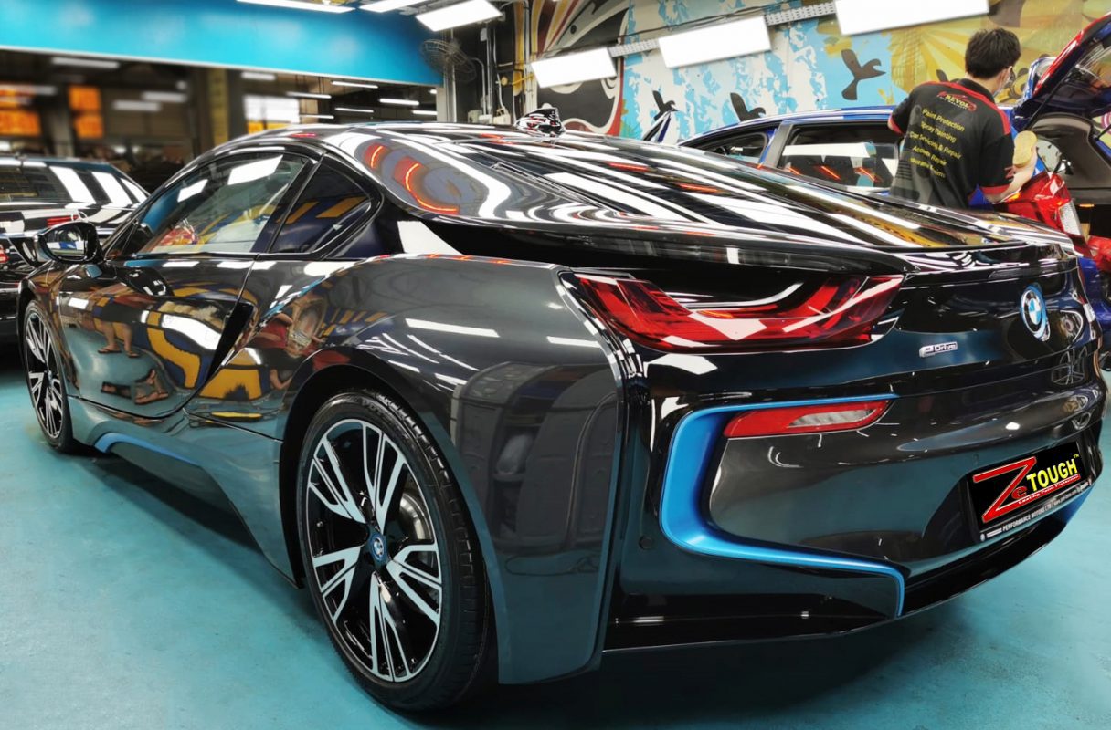 The i8's coated bonnet under workshop lighting.