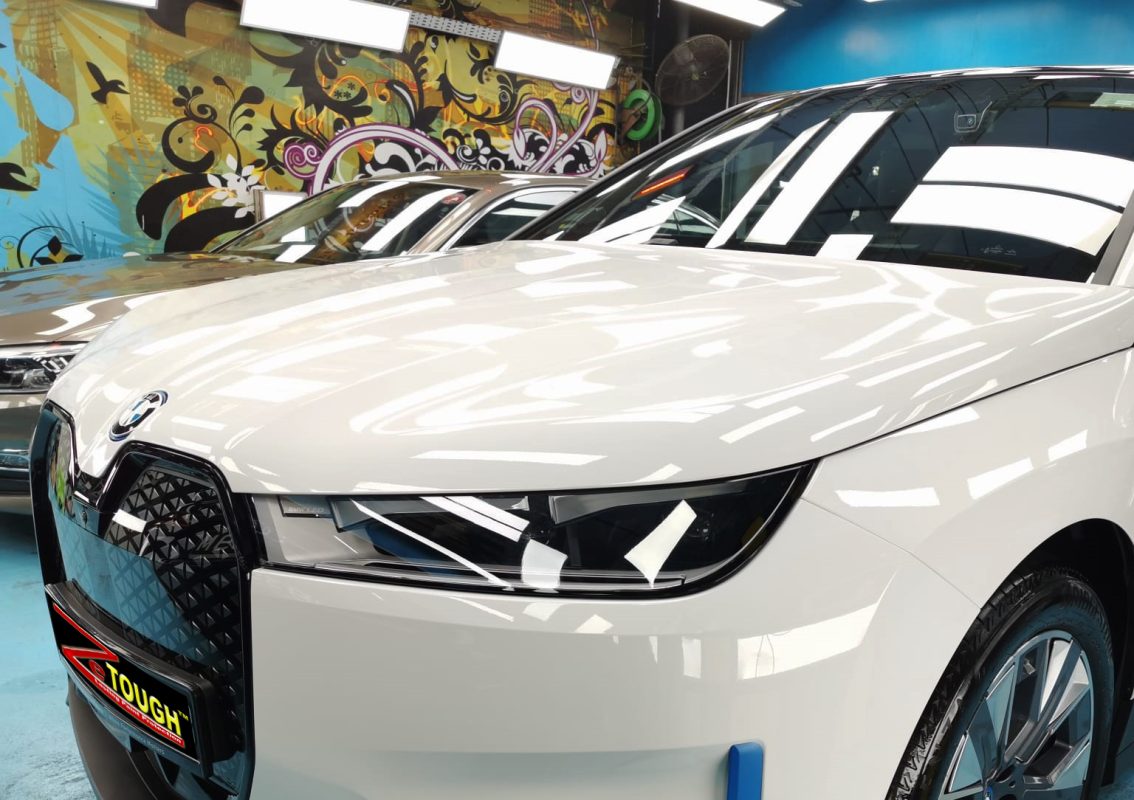 The BMW iX from a side angle after the ceramic coating.