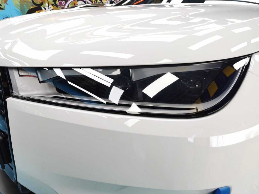 The iX's coated paintwork showing clean reflections.