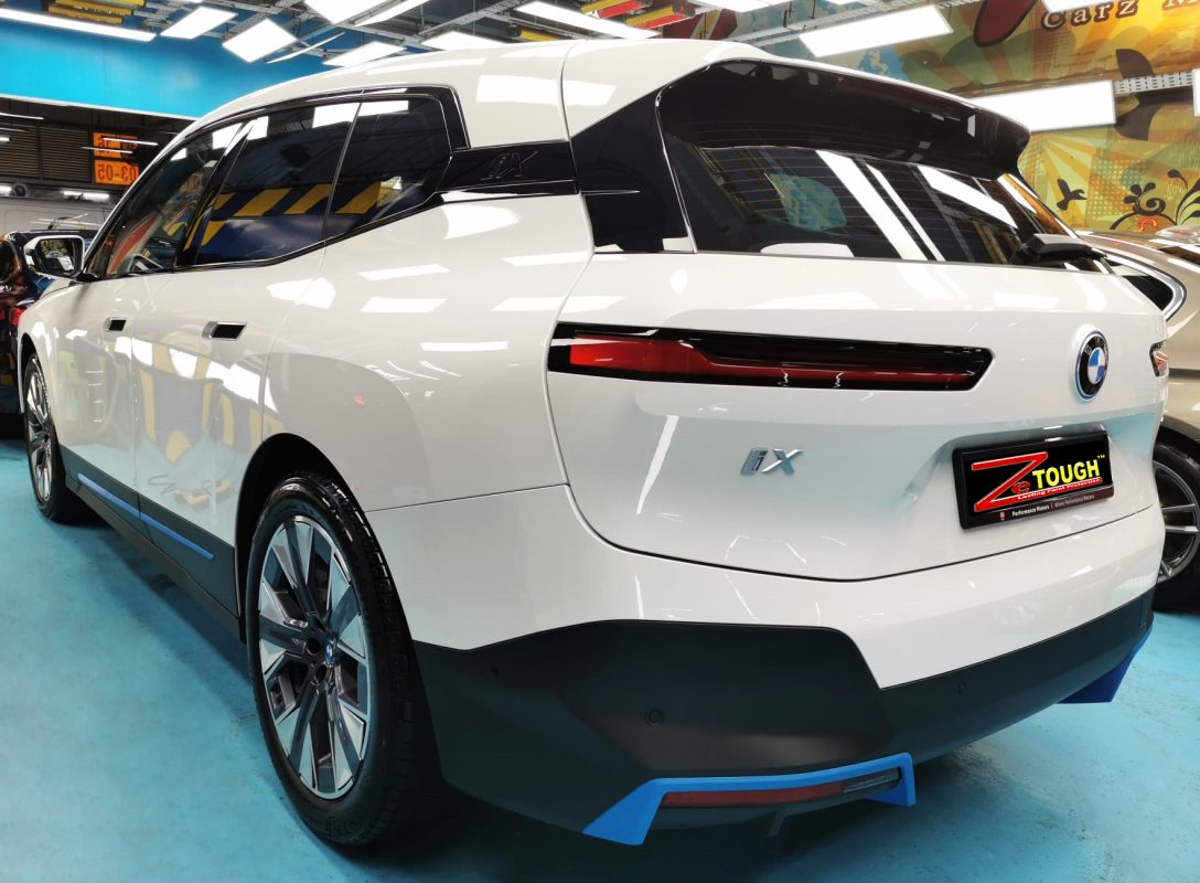 Rear quarter of the BMW iX, glossy and protected.
