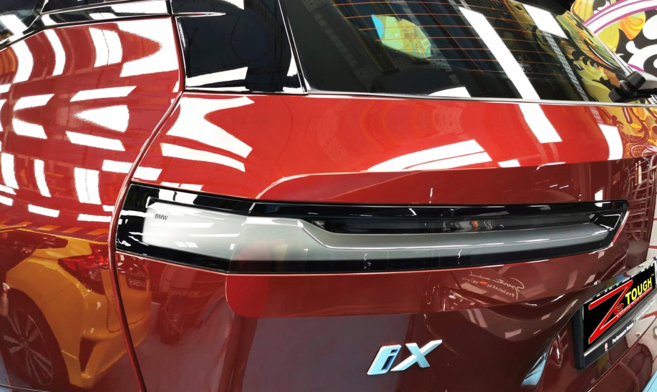 Rear quarter of the BMW iX, glossy and protected.