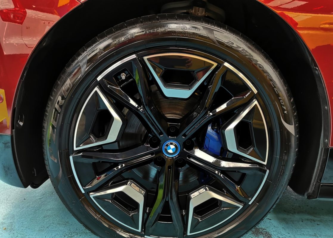 The coated bonnet of the BMW iX under workshop lighting.