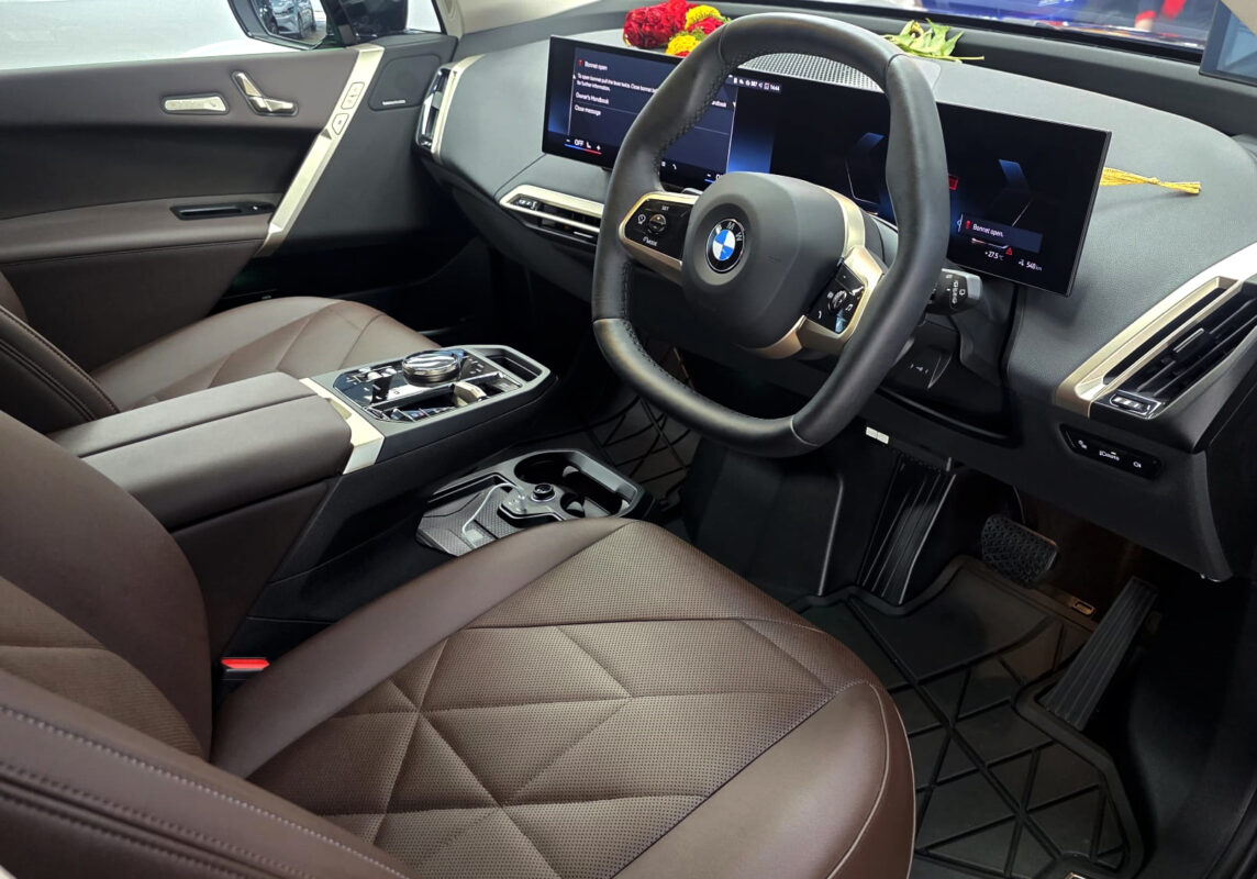 Reflections across the coated panels of the BMW iX.