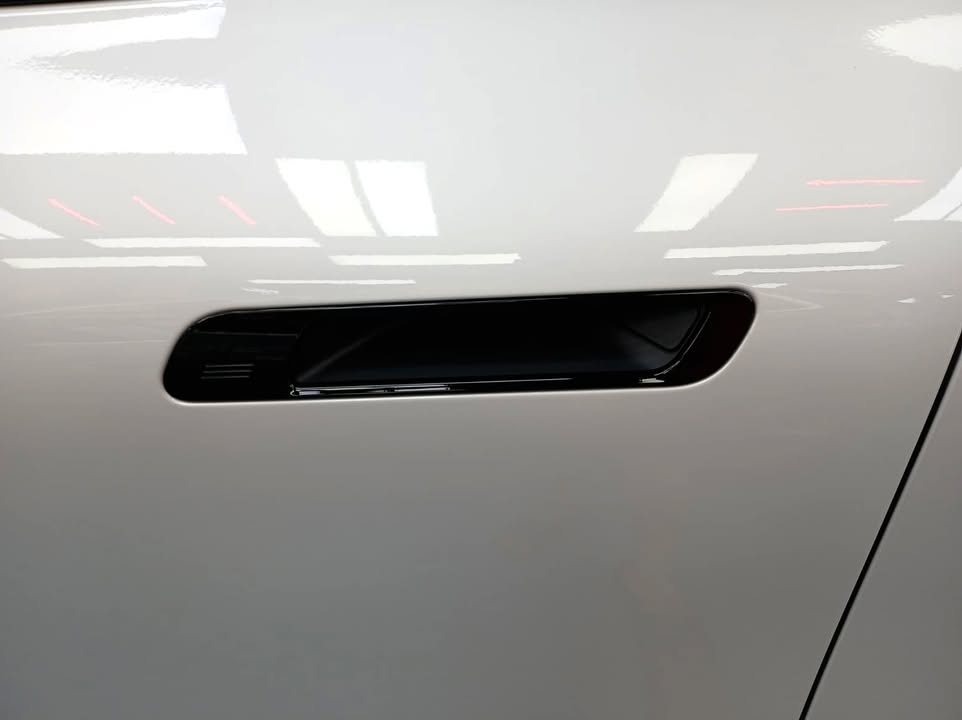 White door panel with recessed flush door handle.