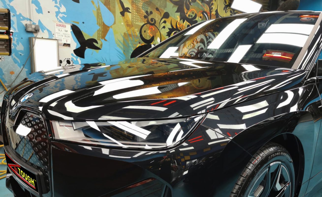 The BMW iX from a side angle after the titanium coating.