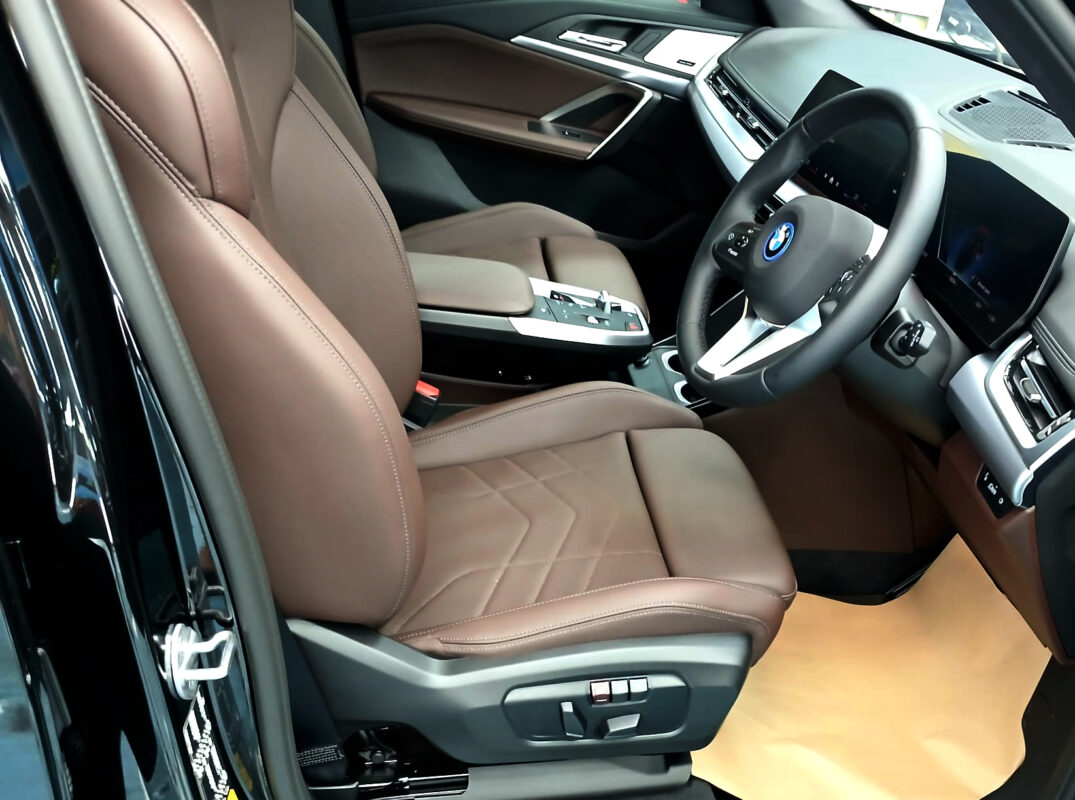 The BMW iX1 parked in the workshop, freshly coated.