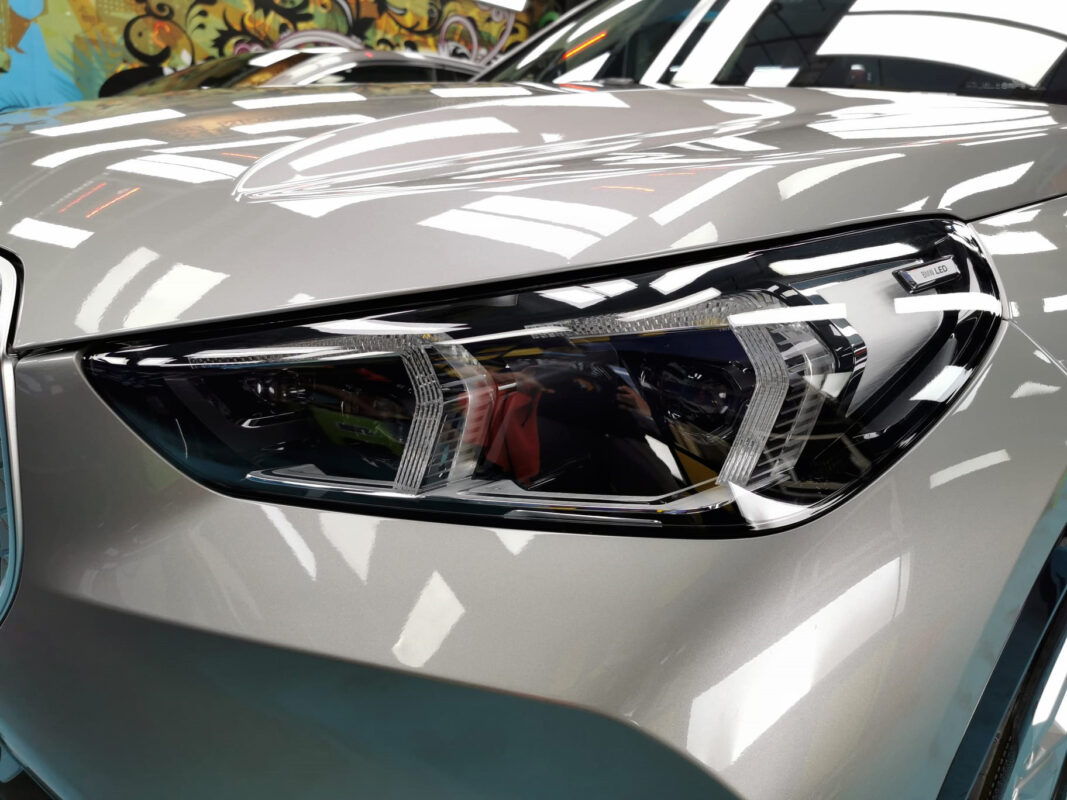 The iX1's coated paintwork showing clean reflections.
