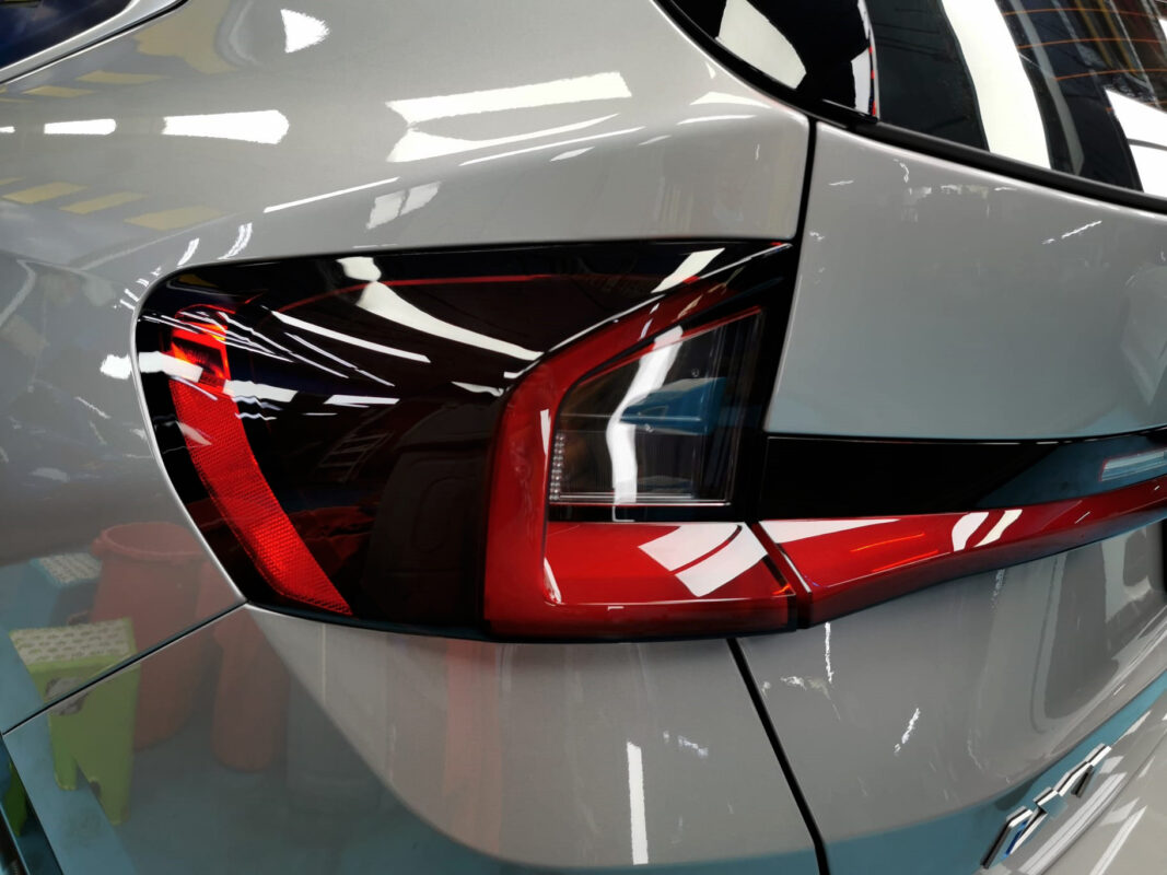 The coated bonnet of the BMW iX1 under workshop lighting.