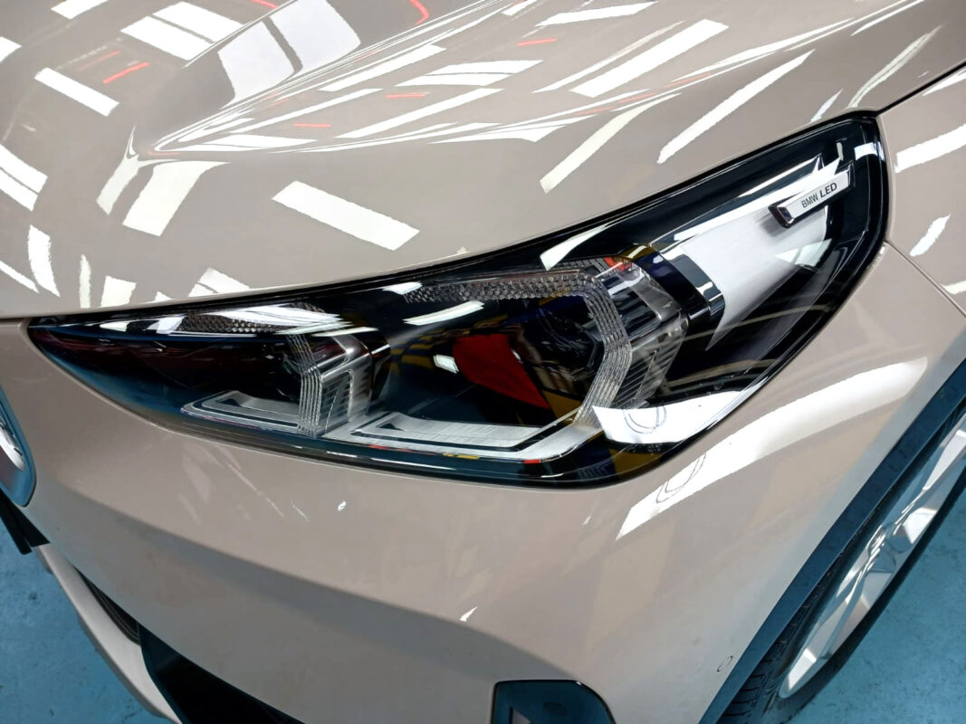 The iX1's coated paintwork showing clean reflections.