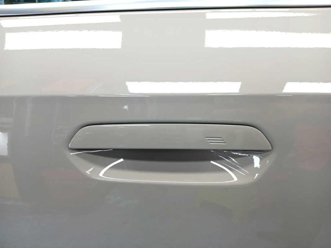 Rear quarter of the BMW iX1, glossy and protected.