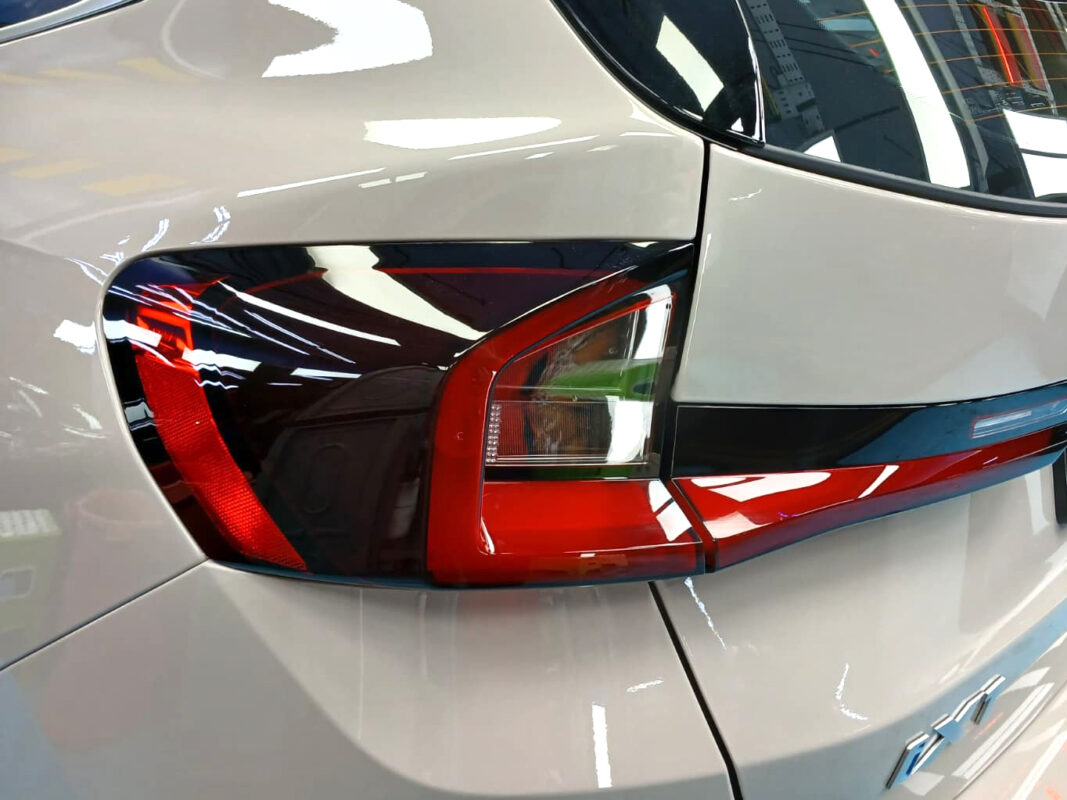 The BMW iX1 parked in the workshop, freshly coated.