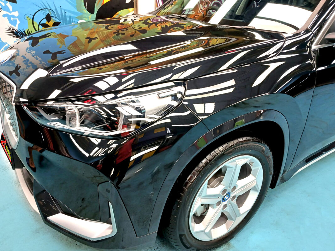 The BMW iX1 from a side angle after the titanium coating.