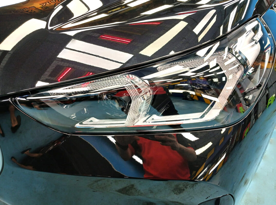 The iX1's coated paintwork showing clean reflections.