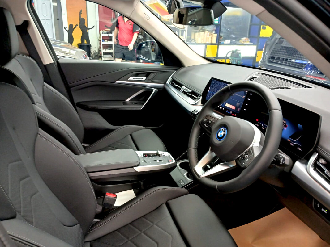 The BMW iX1 parked in the workshop, freshly coated.