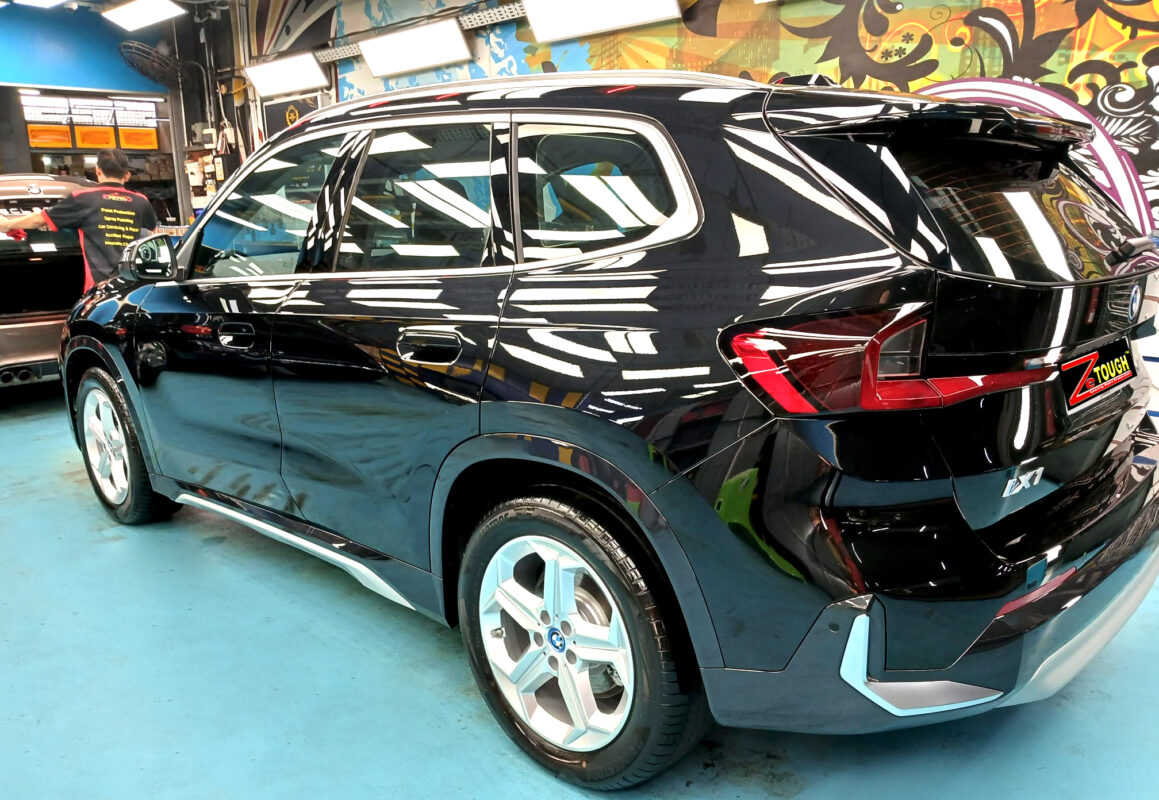 Rear quarter of the BMW iX1, glossy and protected.