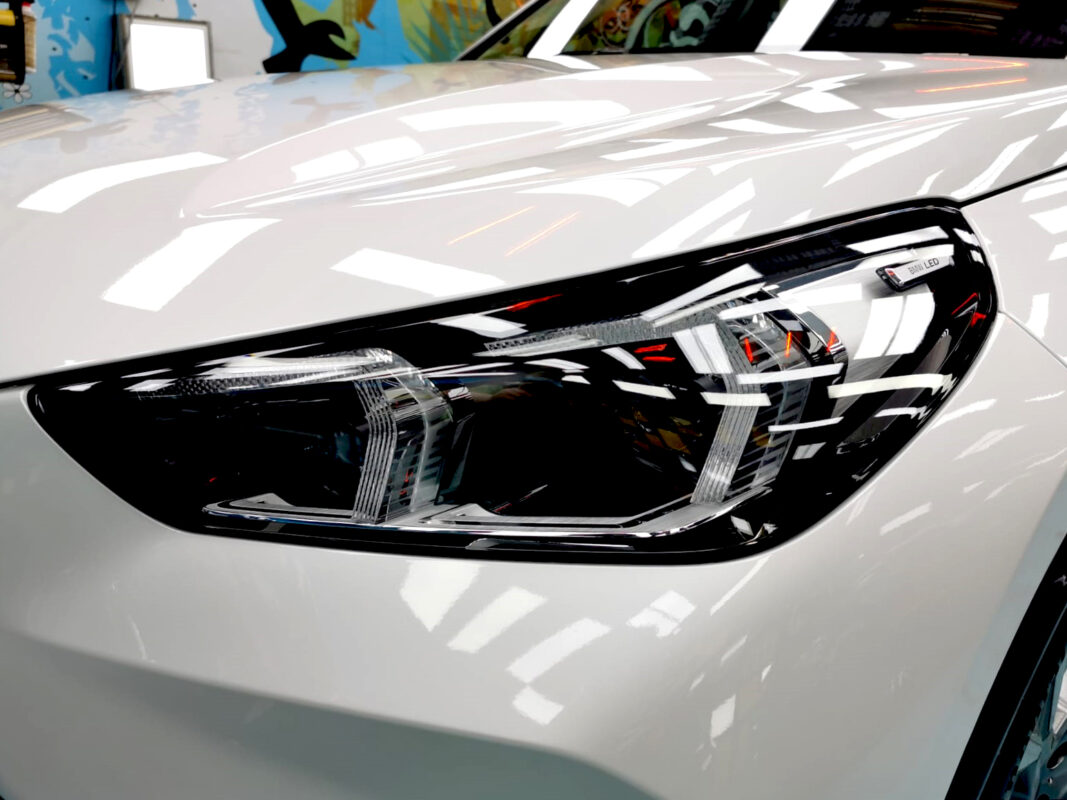 The iX1's coated paintwork showing clean reflections.