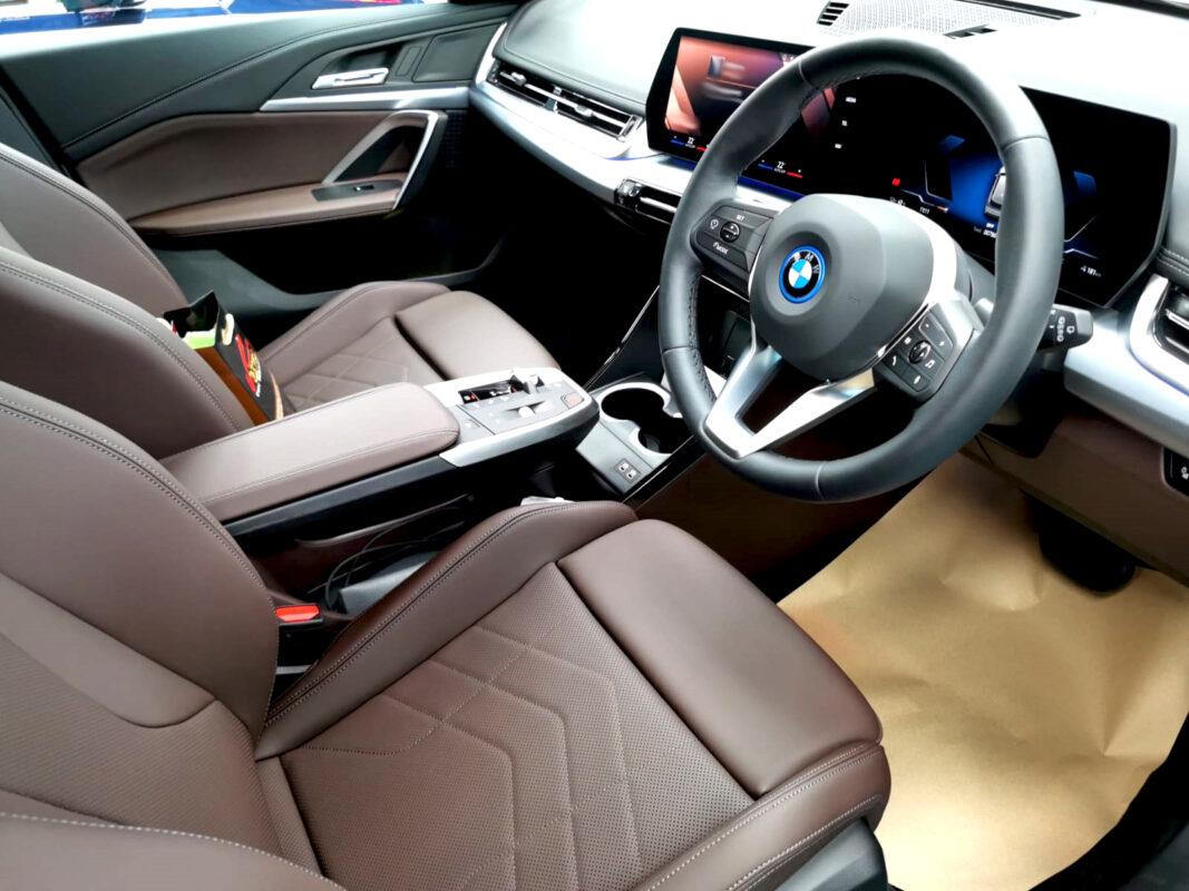 The BMW iX1 parked in the workshop, freshly coated.