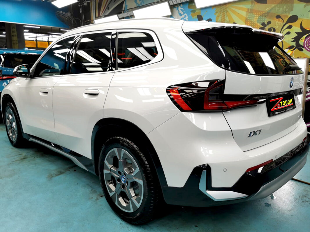 Rear quarter of the BMW iX1, glossy and protected.