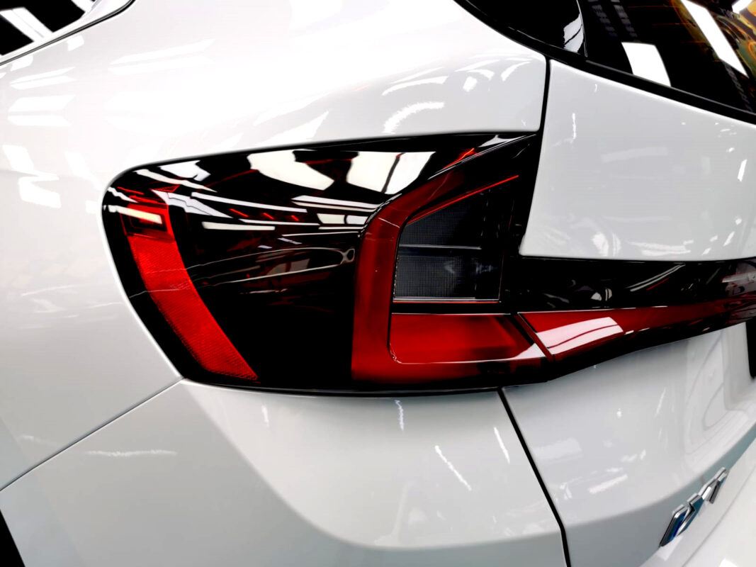 The coated bonnet of the BMW iX1 under workshop lighting.