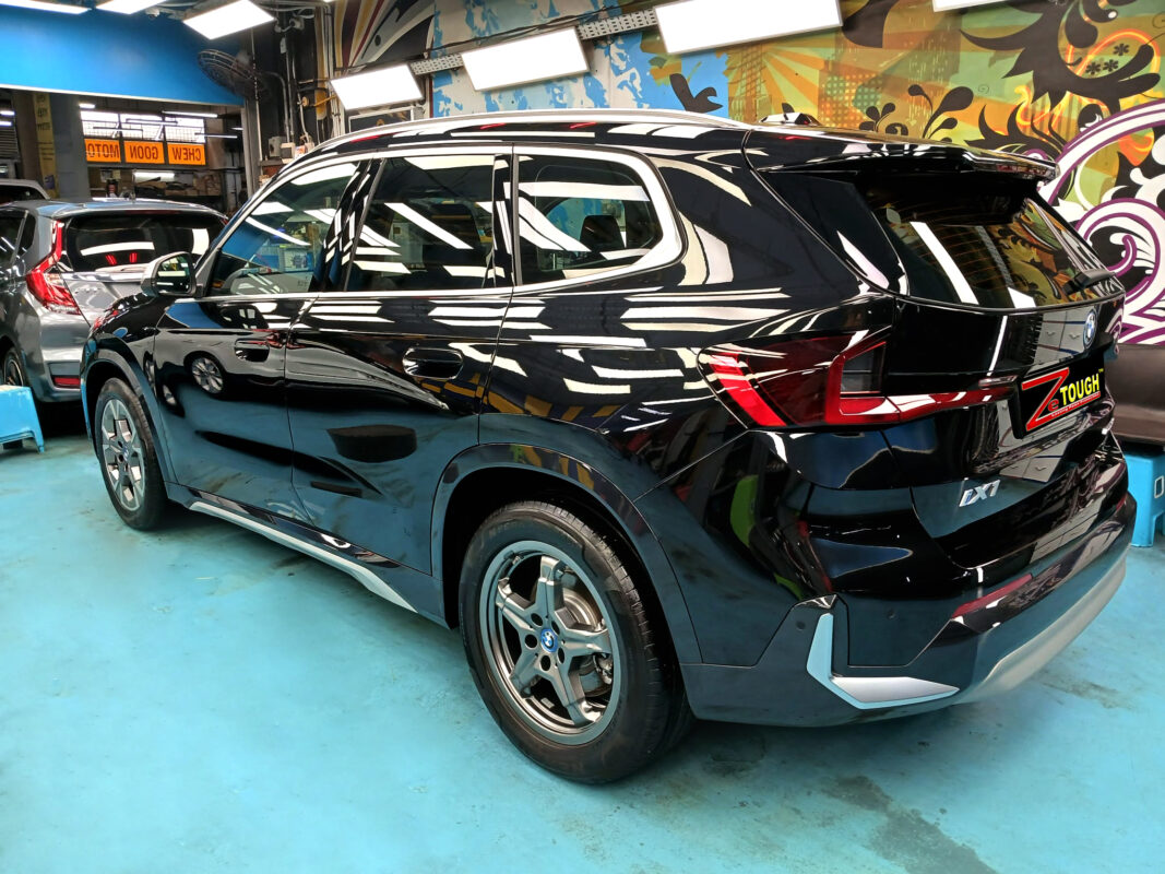 Rear quarter of the BMW iX1, glossy and protected.