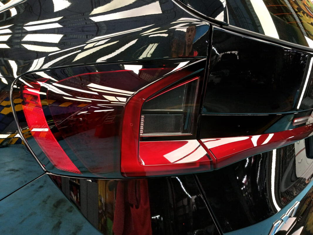 The coated bonnet of the BMW iX1 under workshop lighting.