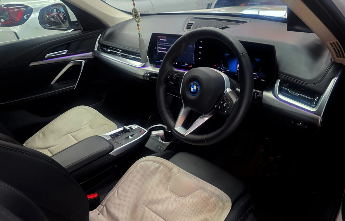 Reflections across the coated panels of the BMW iX1.