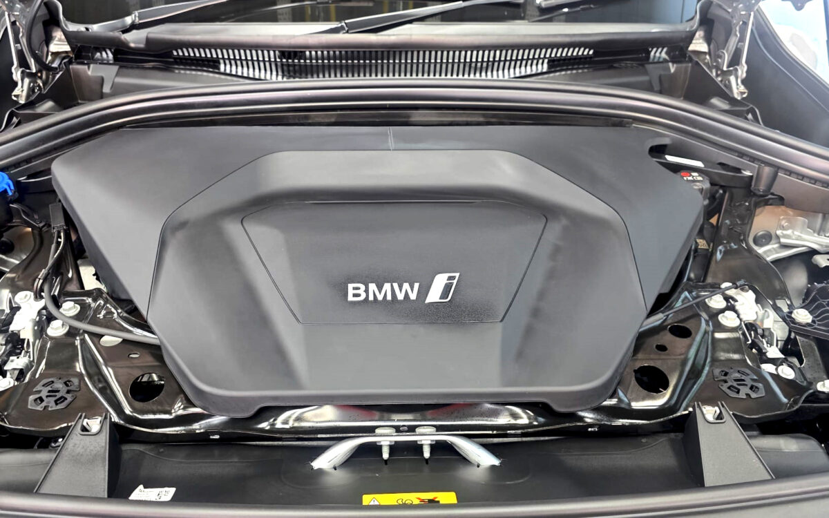 Reflections across the coated panels of the BMW iX1.