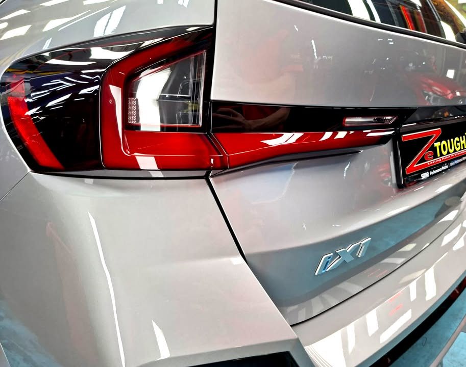 Close-up of the BMW iX1 tail light and tailgate with the iX1 badge.