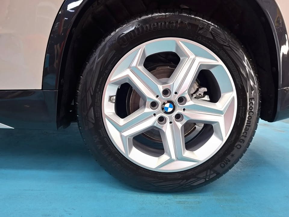 Silver alloy wheel on the BMW iX1.
