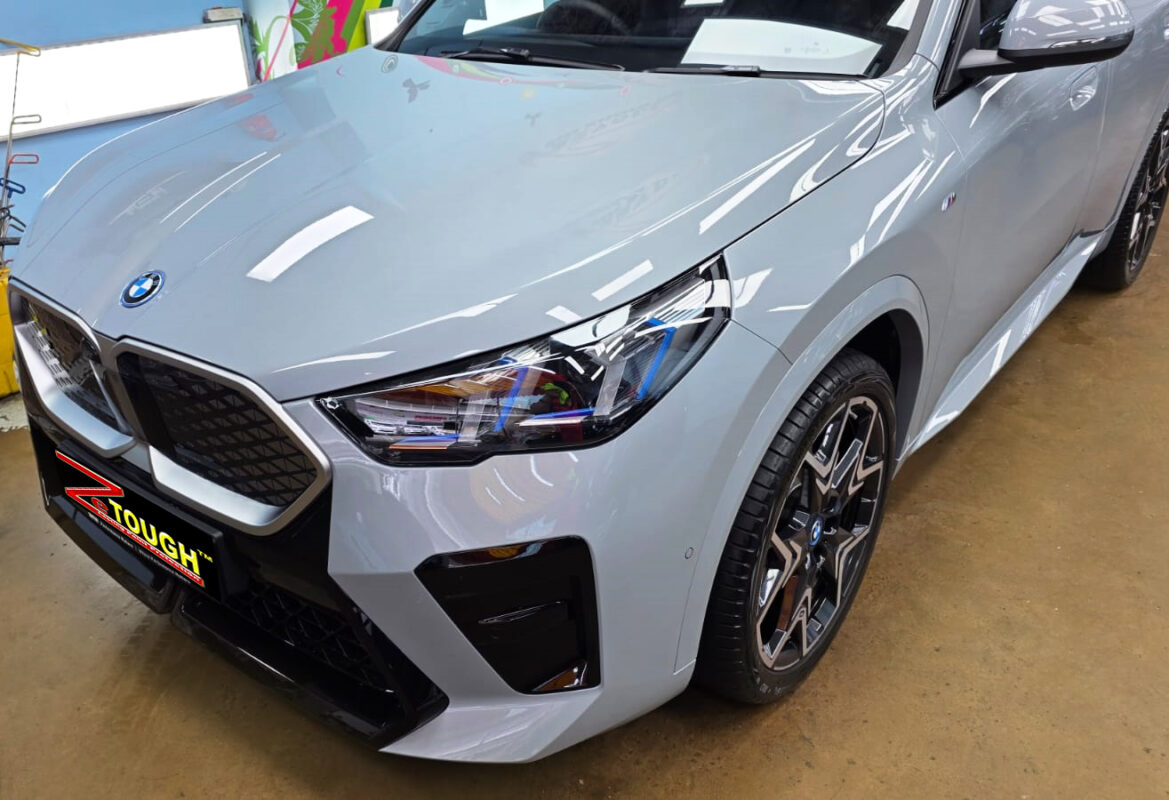 The BMW iX2 from a side angle after the ceramic coating.