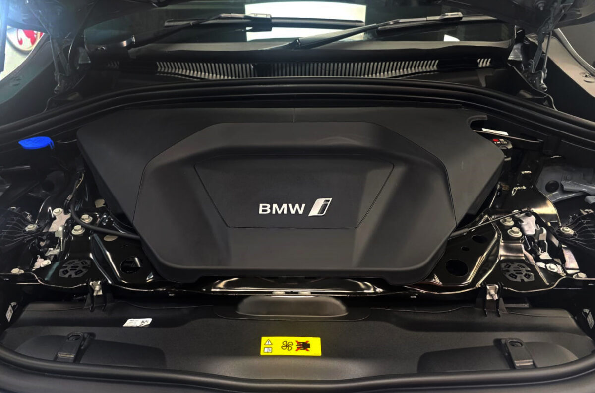 The BMW iX2 parked in the workshop, freshly coated.